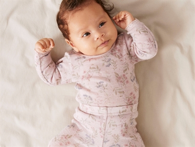 Baby iført Name It body i violet ice med blomsterprint