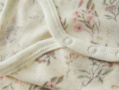Name It råhvid bodystocking i merinould til baby med blomster