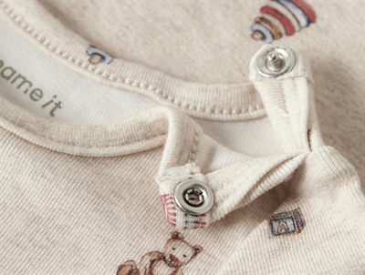 Detalje af trykknapper på råhvid rib body fra Name It