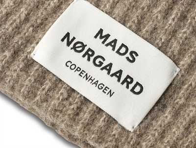 Logolabel på Anju hue i brun nuance fra Mads Nørgaard