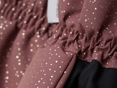 Detaljebillede af En Fant luffer i frosted almond med guldprikker og sort greb