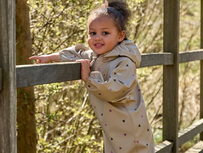 Pige iklædt CeLaVi regndragt white pepper med hjerteprint